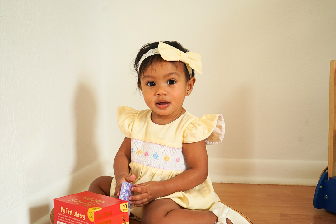 Yellow Baby girl Smocked romper. Hand embroidered with Hair Bow